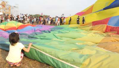 pattaya Thailand balloon fest 2011 a young spectator gives a balloon the once over
