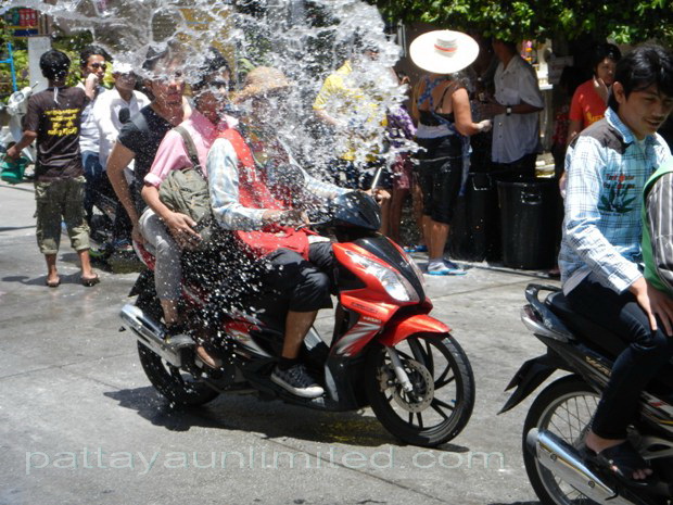 Songkran Thailand motorcyclists get a drenching during the Thai Songkran festival in Pattaya Thailand