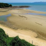 beach at the bottom of a hill