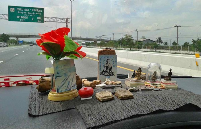 Buddhist Amulets on a car dashboard