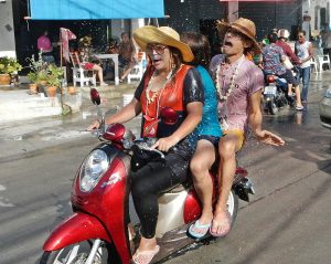 riding a motorcycle during Songkran in Pattaya, Thailand
