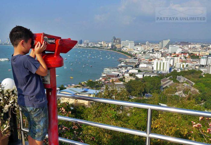 Young boy looking through tower viewers at Pattaya viewing point