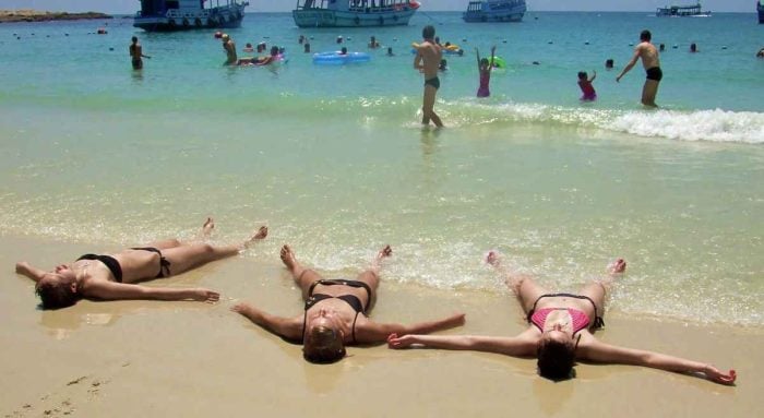 Western women sunbathing on the beach on Samet island in Thailand