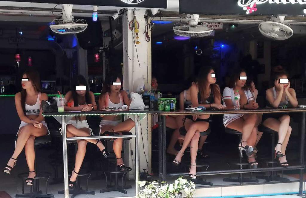 Thai bar girls waiting for customers on soi 6 in Pattaya Thailand