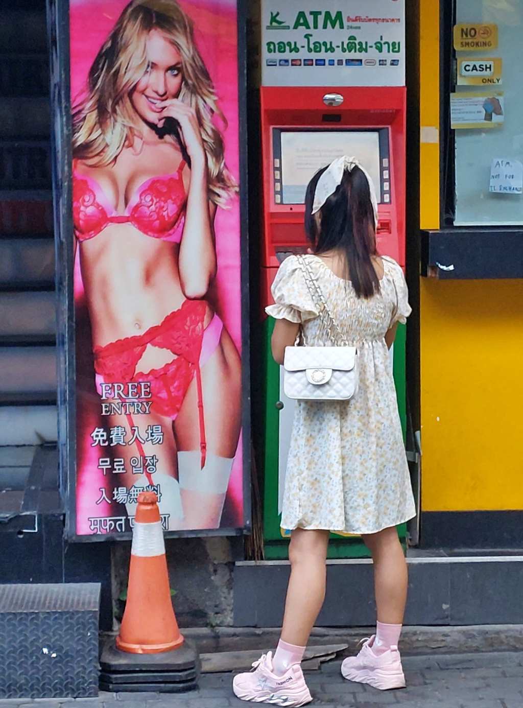 Thai girl at the ATM in Walking Street, Pattaya
