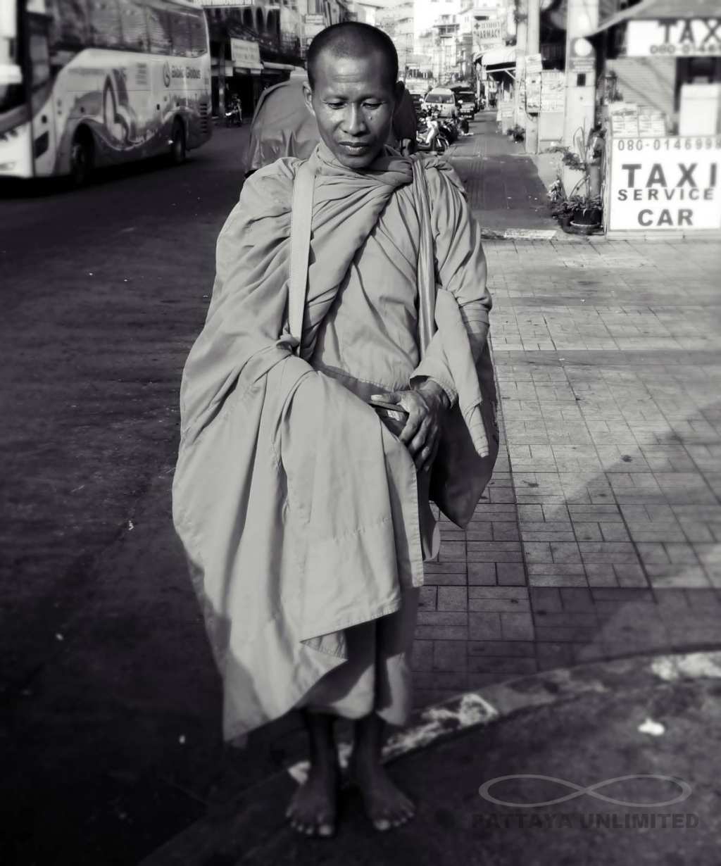 Buddhist monk collecting alms in downtown Pattaya